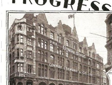 A sepia photograph of a large stone corner building with an ornate gabled roofline flying a Union flag, its facade lettered Conway Stewart and Co Ltd.